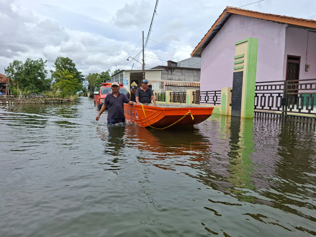TRANSPORTASI: Warga terdampak banjir menggunakan perahu sebagai alat transportasi maupun alat bantu di kala banjir, Rabu (21/1). (ANDIKA TRISNA SAPUTRA/RADAR KUDUS)