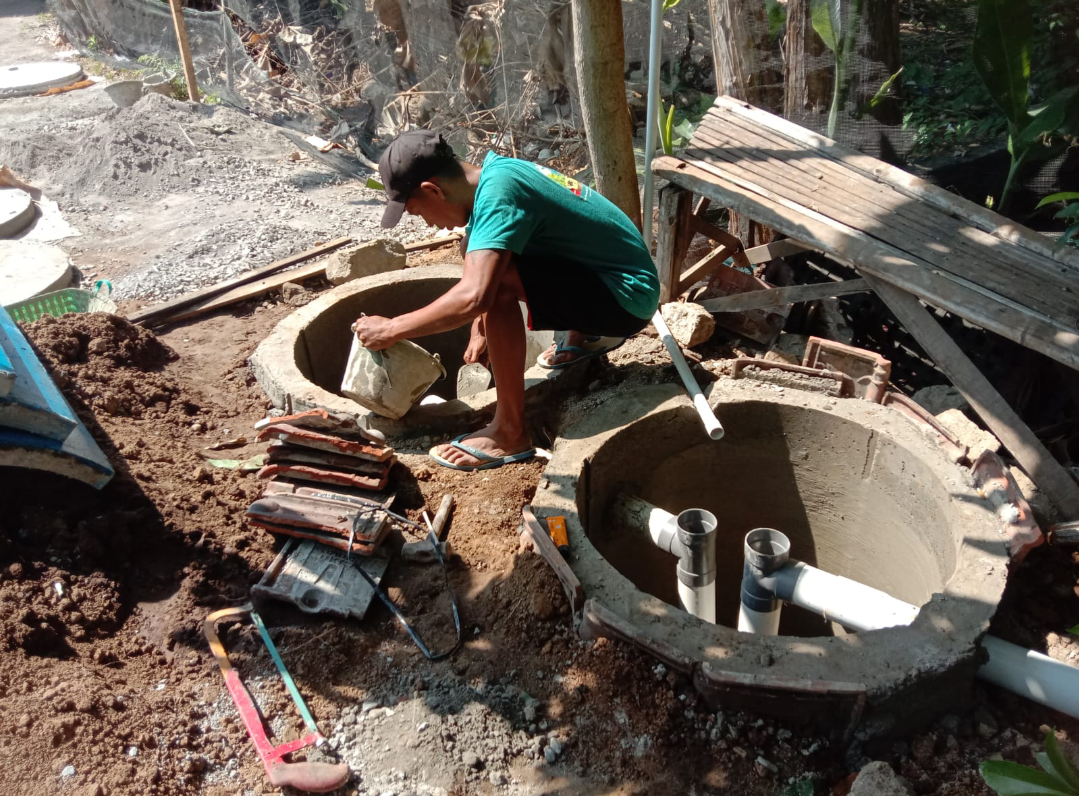 PROSES: Tukang bangunan sedang mengerjakan pembuatan septic tank terkait Program Sanitasi Terpadu PT Djarum, belum lama ini. (PT DJARUM UNTUK RADAR KUDUS)
