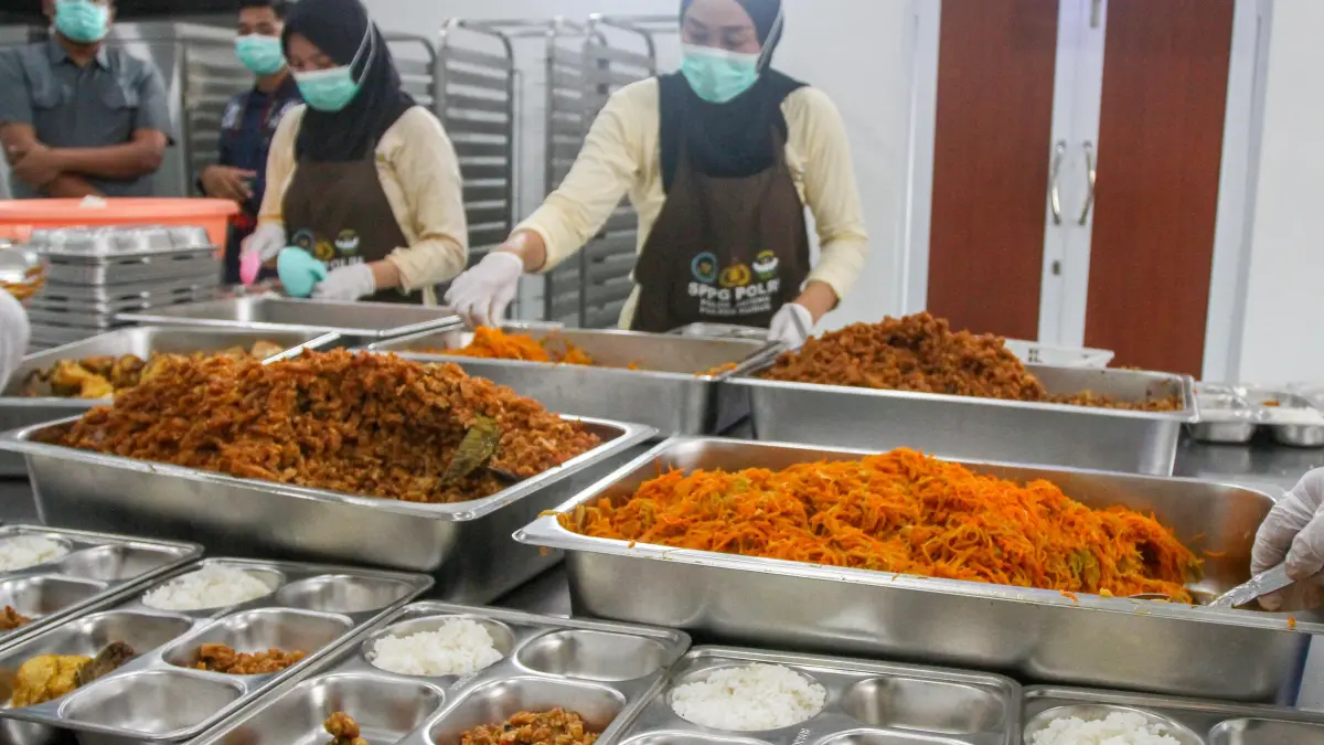 DISAJIKAN: Petugas SPPG Polres Kudus menata masakan MBG untuk distribusikan ke sekolah.