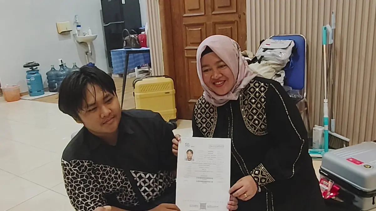 PERSIAPAN BERANGKAT – Athaya Putra Agfhani haji Termuda Grobogan  bersama ibunya Anita Fitriani sedang menunjukan surat surat berangkat haji dan persiapan berangkan haji tahun 2026.  