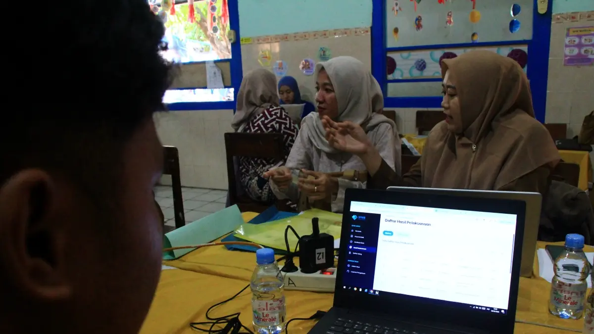 PERLU EVALUASI: Petugas SPMB di SDN Kutoharjo IV mencermati urutan siswa yang mendaftar di sekolahnya. (WISNU AJI/RADAR KUDUS)