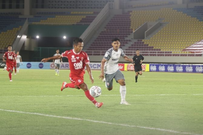 BERAKHIR IMBANG: Crah Angger menendang bola dibayang-bayangi pemain Persis Solo Heri Susanto tadi malam. (RADAR SOLO FOR RADAR KUDUS)