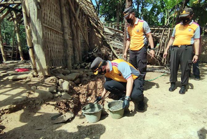 BAKTI SOSIAL: Kapolres Jepara AKBP Warsono turun langsung membantu warga Desa Damarjati dengan melatakkan batu pertama pada program bedah rumah kemarin.  (POLRES FOR RADAR KUDUS)
