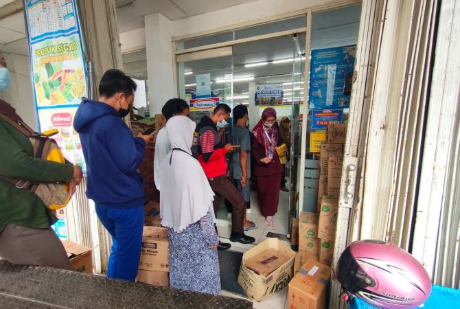 TUNGGU GILIRAN: Emak-emak tampak antre menunggu giliran untuk mendapatkan migor dari minimarket, Selasa (15/3). (WISNU AJI/RADAR KUDUS)