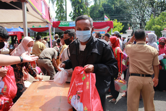 BERJUBEL: Sekitar lima ratus warga berjubel mengambil bantuan dan membeli barang di bazaar pasar murah di lapangan Setda Grobogan, Selas (26/4). (SIROJUL MUNIR/RADAR KUDUS)