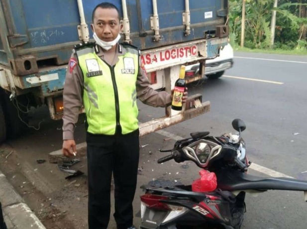 BARANG BUKTI: Anggota polisi mengamankan botol miras di TKP kecealakaan. (DOK. RADAR KUDUS)
