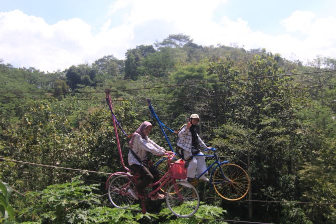 WISATA ALAM: Pengunjung The Hilss Vaganza menikmati wahana sepeda gantung. (DONNY SETYAWAN/RADAR KUDUS)