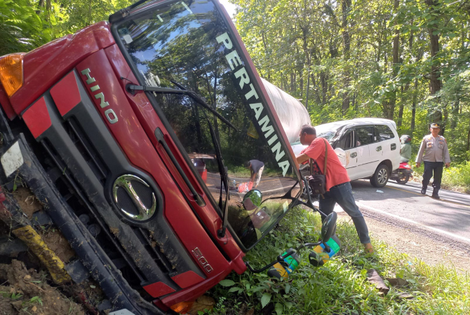 RINGSEK: Mobil Innova bernopol AB 1922 VK ringsek usai tertindih Truk tangki pertamina bernopol AD 1910 BP yang terguling di jalan nasional Cepu-Blora, Minggu (20/11) malam. (AHMAD ZA