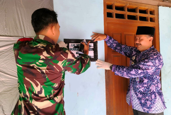 BERI TANDA: Camat Kragan, Nur Rofik ikut sampling penyemprotan rumah bertuliskan warga miskin di Sumurtawang, Kragan belum lama ini. (KECAMATAN KRAGAN FOR RADAR KUDUS)