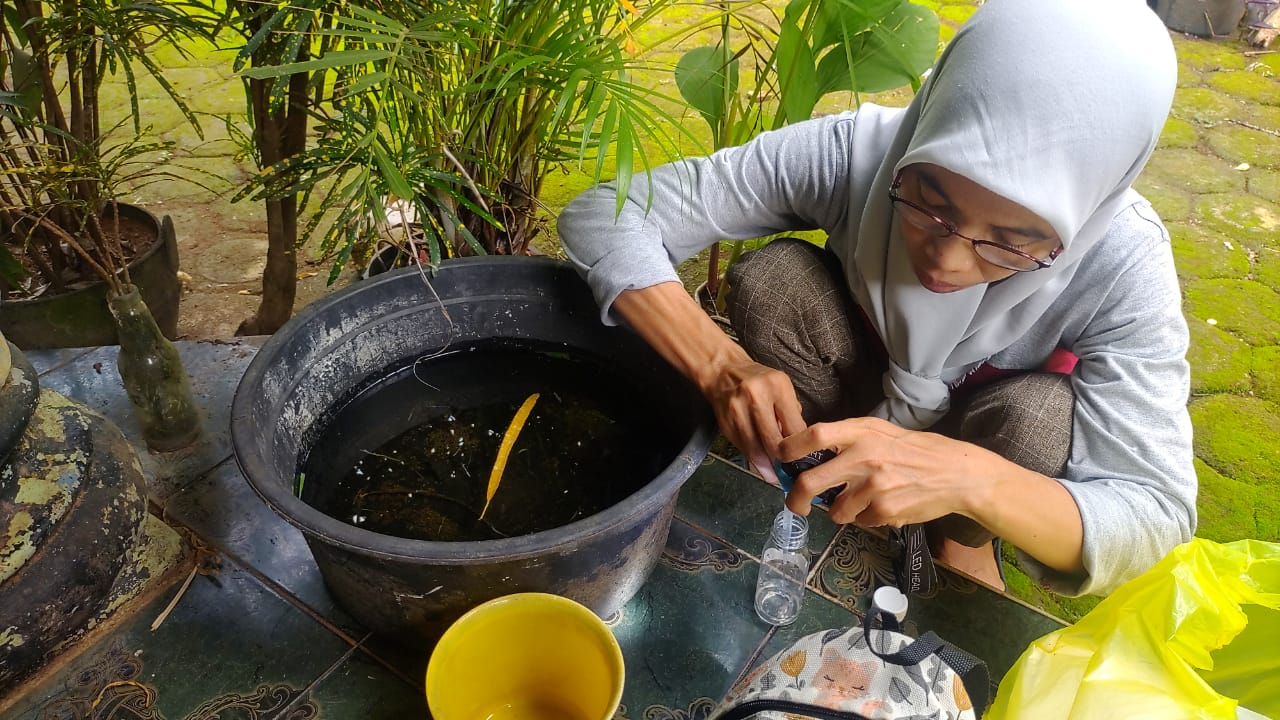 BAHAYA: Petugas mengecek kandungan jentik di salah satu penampungan air milik warga di Kecamatan Kedung belum lama ini. (DINKES JEPARA UNTUK RADAR KUDUS)