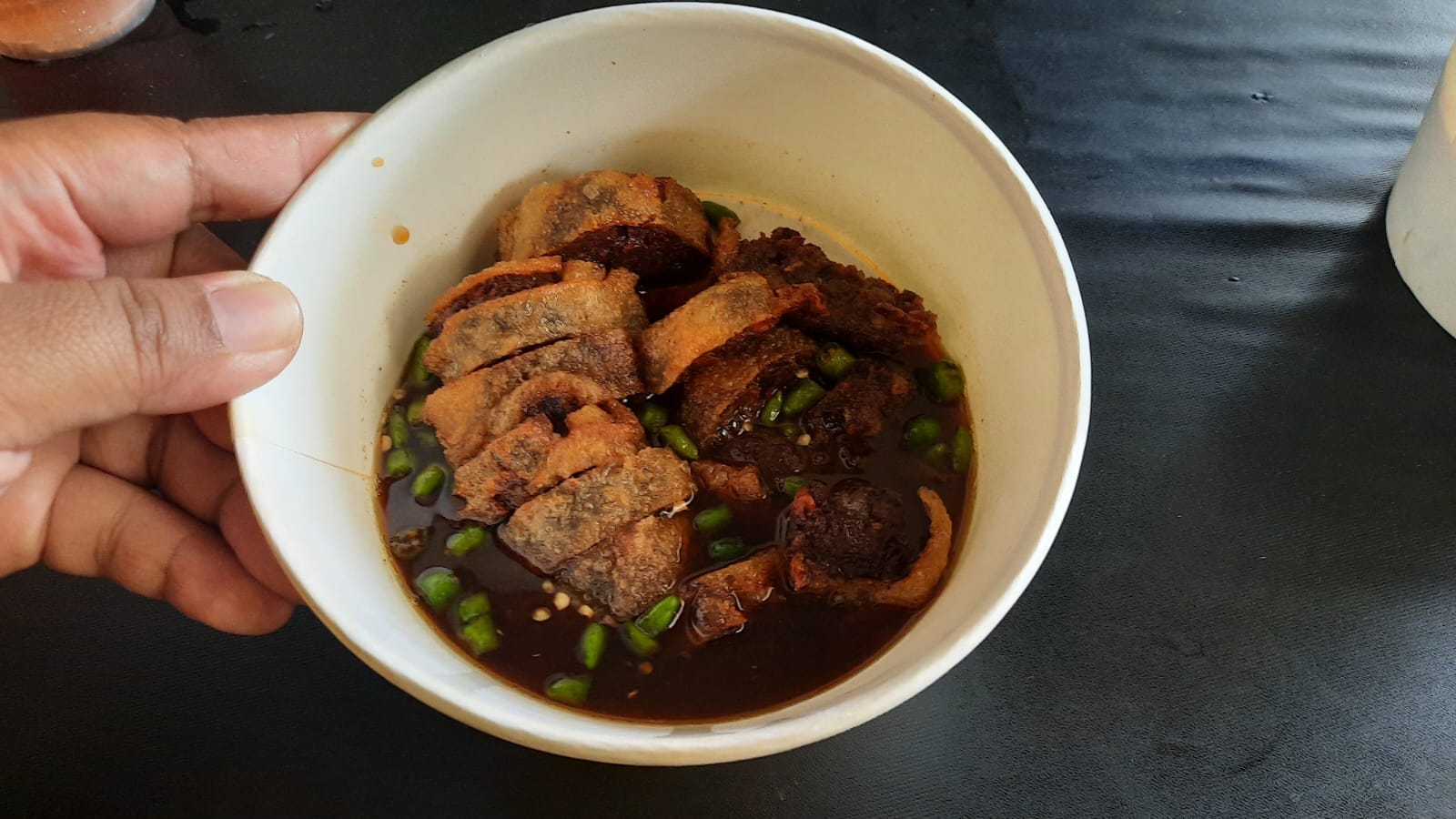 MENIKMATI GOHYONG: Ninda saat menikmati makanan Gohyong yang lagi populer sekarang ini di kedai Wontonova.id kemarin. (INDAH SUSANTI/RADAR KUDUS)