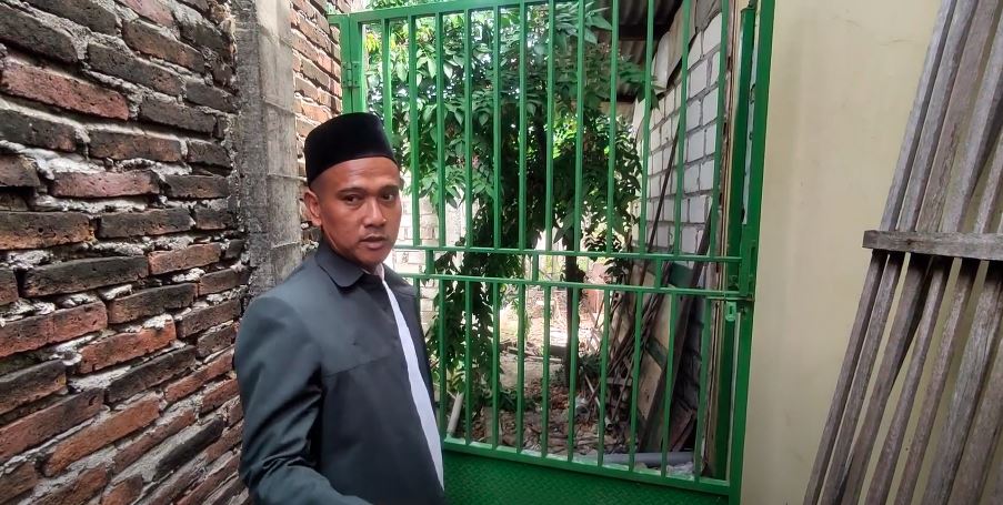 DITUNJUKKAN: Ahmad Rozi menunjukkan pintu samping rumah yang digunakan pelaku menyusup di kediaman Siti Muawanah di Desa Sokopuluhan, Pucakwangi belum lama ini.&nbsp; (ANDRE FAIDHIL FALAH/RADAR KUDUS)