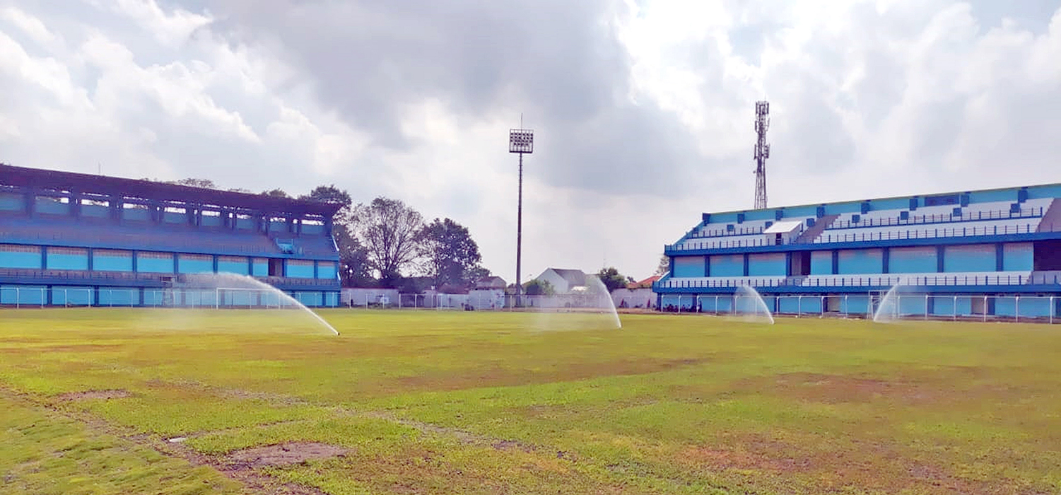 BERUBAH TOTAL: Proses penyiraman rumput dengan sprinkler pada lapangan Stadion Wergu Wetan. (GALIH ERLAMBANG W/&nbsp;RADARPATI.ID)