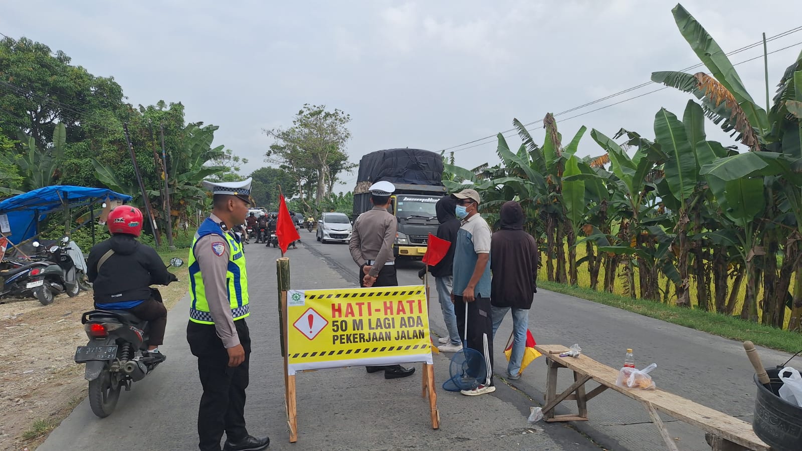 KOORDINASI: Kanit Kamsel Satlantas Polres Grobogan saat berkoordinasi urai kemacetan jalur Purwodadi-Semarang tepatnya di Desa Pulorejo Kecamatan Purwodadi.