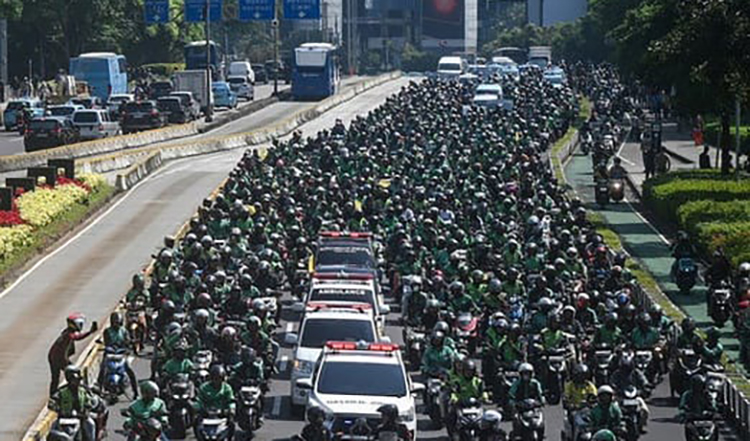 Para pengemudi ojek online (ojol) beriringan mengantarkan ambulans berisi jenazah rekan mereka, Affan Kurniawan menuju pemakaman di Jalan Jenderal Sudirman, Jakarta, Jumat (29/8/2025)