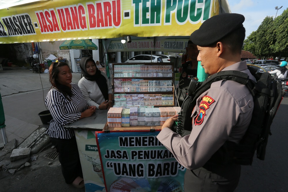  KEWASPADAAN: Polisi mengecek jasa tukar uang menjelang Lebaran. (GALIH ERLAMBANG W/ RADAR PATI)