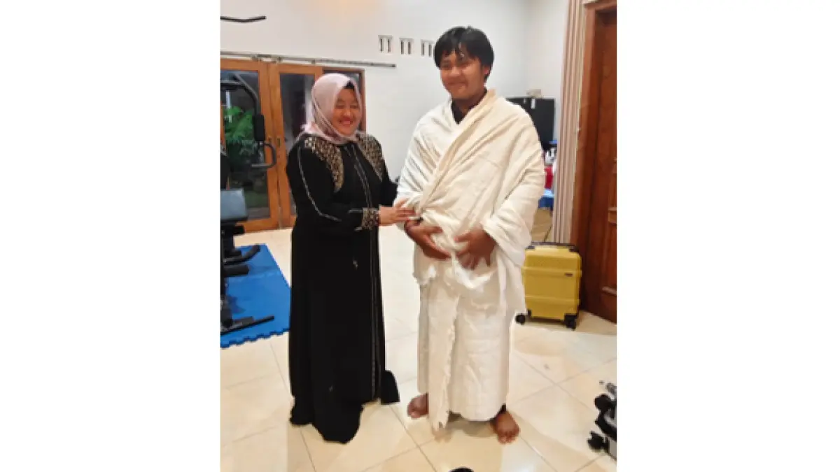 
PANGGILAN ILAHI: Athaya Putra Agfhani, calon jamaah haji termuda asal Grobogan  bersama ibunya Anita Fitriani mencoba pakaian ihram. (SIROJUL MUNIR/RADAR PATI) 