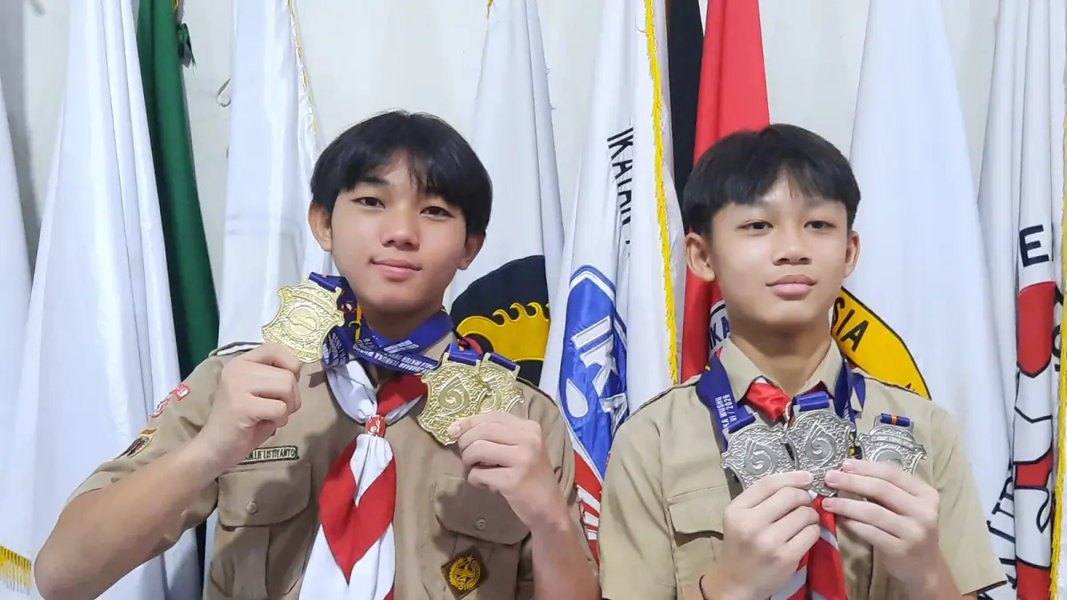 JUARA: Kenichi Rain Lie Listiyanto (kiri) dari SMP 2 Kudus dan Jason Nathanael Dharma murid SD Masehi Kudus memperlihat medali yang diraihnya. (INDAH SUSANTI/RADAR PATI)
