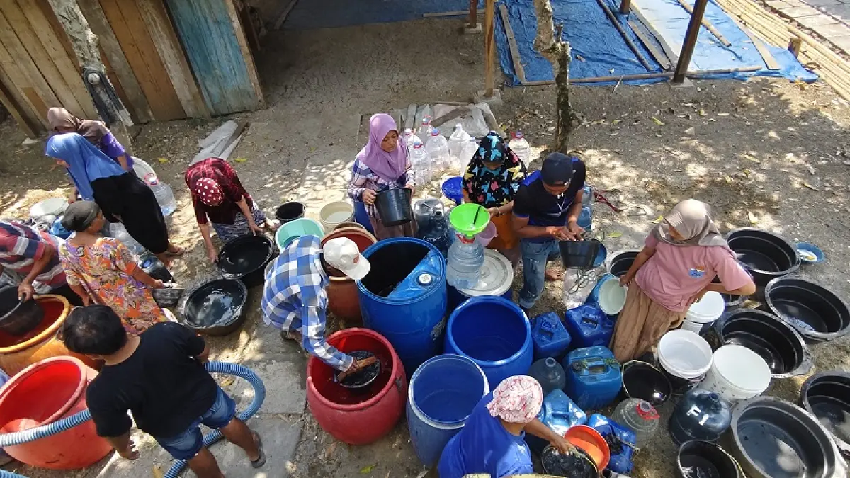 DROPPING AIR: Warga Kecamatan&nbsp;Gabus mengambil air yang disalurkan relawan SMKN 2&nbsp;Purwodadi bersama BPBD Grobogan. (SIROJUL MUNIR/RADAR PATI)