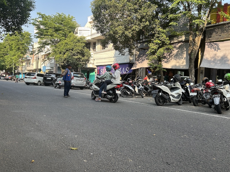 PERLU DIEVALUASI: Juru parkir (jukir) mengawal pengguna jasa parkir di Jalan Panglima Sudirman Bangkalan, Kamis (16/10).&nbsp;