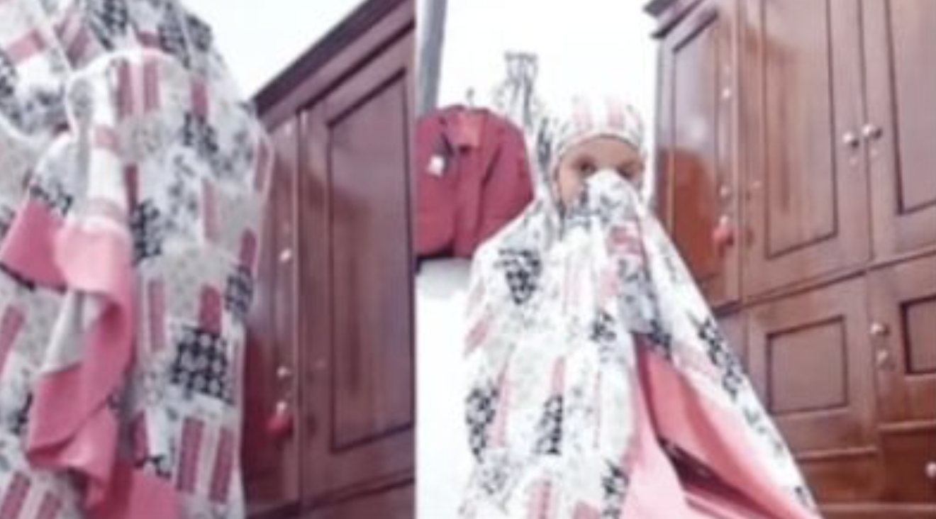 Viral video seorang wanita pakai mukena pink.