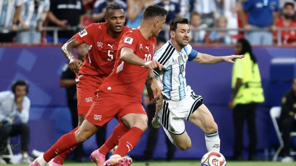Gelandang Timnas Swiss nomor punggung 10, Granit Xhaka, dan penyerang Timnas Argentina nomor punggung 10, Lionel Messi, berebut bola selama pertandingan perempat final Piala Dunia 2026 antara Argentina vs Swiss di Kansas City Stadium, Kansas City, pada Minggu
(12/7/2026) pagi WIB. (AFP/CHARLY TRIBALLEAU)