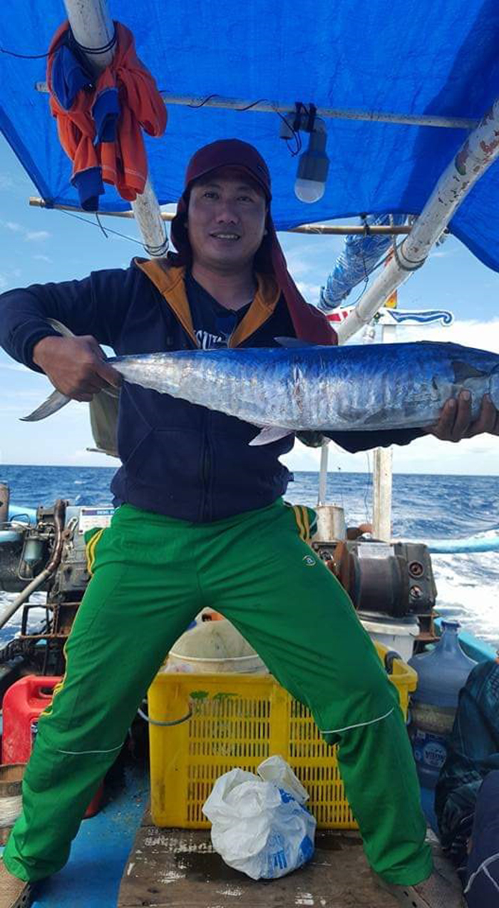 Fahmi Fikroni, menunjukkan ikan hasil pancingannya di perairan laut Tuban, Jawa Timur.
