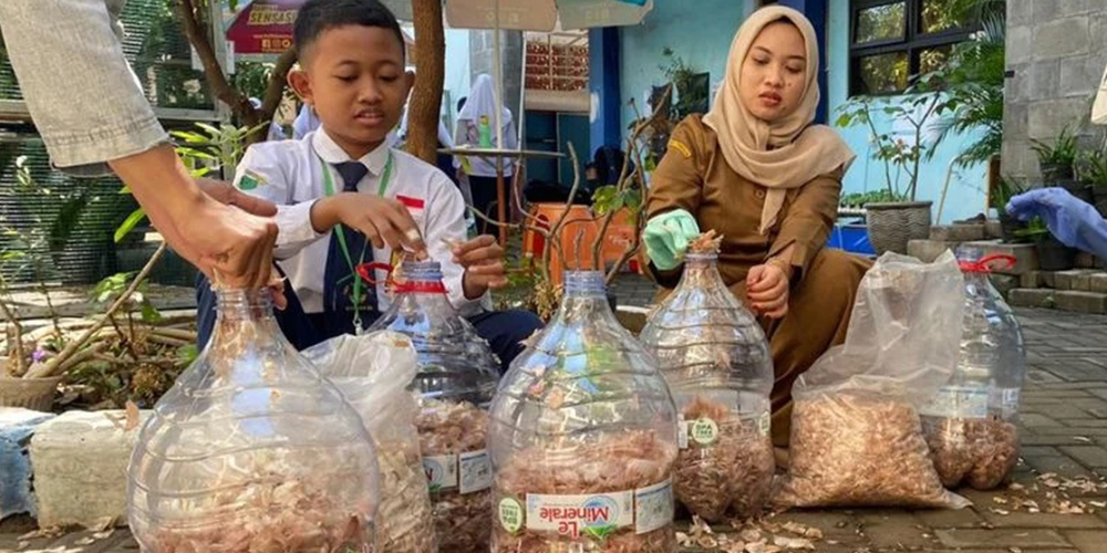 Raihan Jouzu Syamsudin, siswa SMPN 57 Surabaya, bersama guru pembimbing mengolah limbah kulit bawang putih menjadi bahan dasar tinta spidol ramah lingkungan yang kini menarik perhatian banyak sekolah.