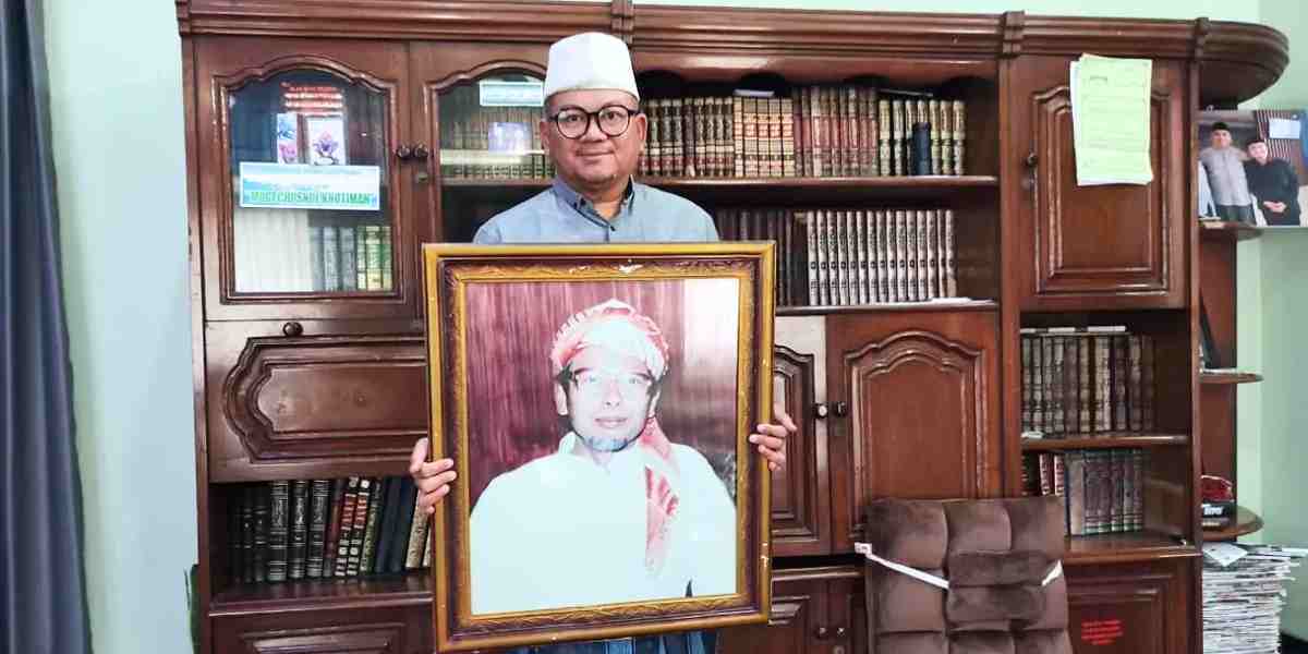 KH Riza Shalihuddin Habibi saat berfoto bersama foto KH Ahmad Syifa Sholih, Rabu (18/2).