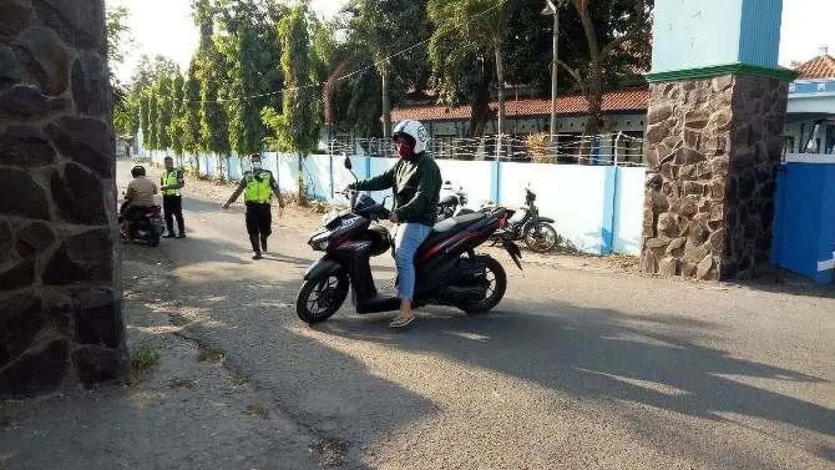 Seorang pengendara motor di Gorontalo menabrak dan menindih polantas saat razia, insiden berakhir damai setelah pelaku meminta maaf secara langsung. (Sumber: radarmojokerto-jawapos-com)