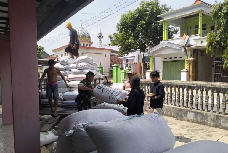 Babinsa Kelurahan Kelutan membantu petani menyetorkan hasil panen ke Gudang Bulog