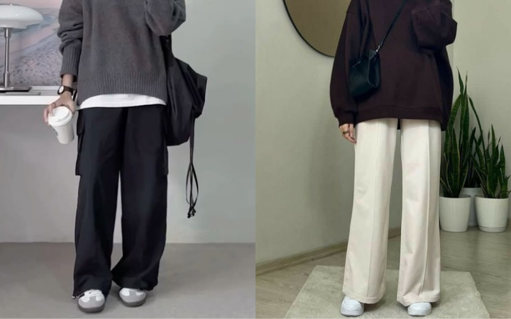 Seorang foto mirror mengenakan outfit monokrom hitam putih di depan cermin.