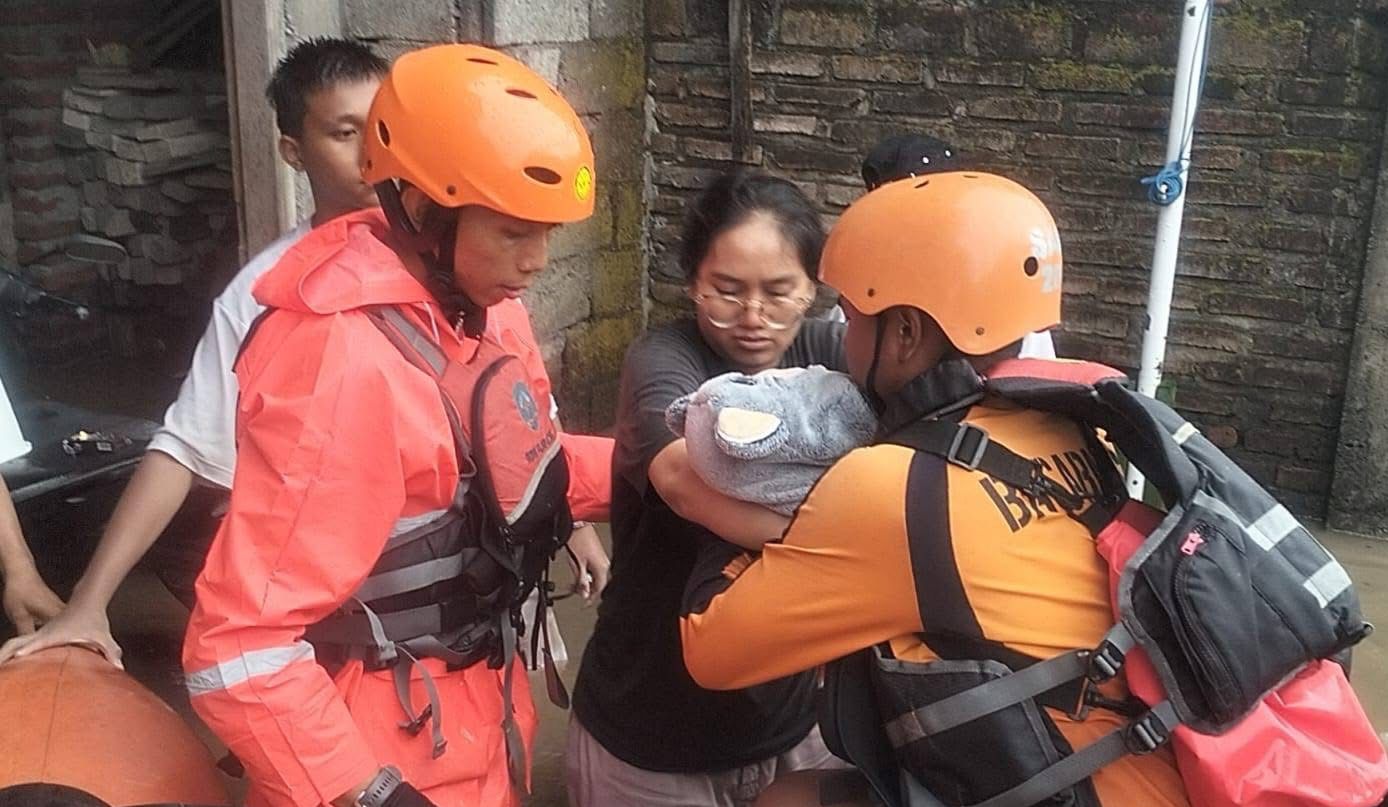 EVAKUASI: Tim SAR saat melakukan evakuasi balita yang terjebak banjir di kawasan Denpasar, Rabu 10 September 2025.