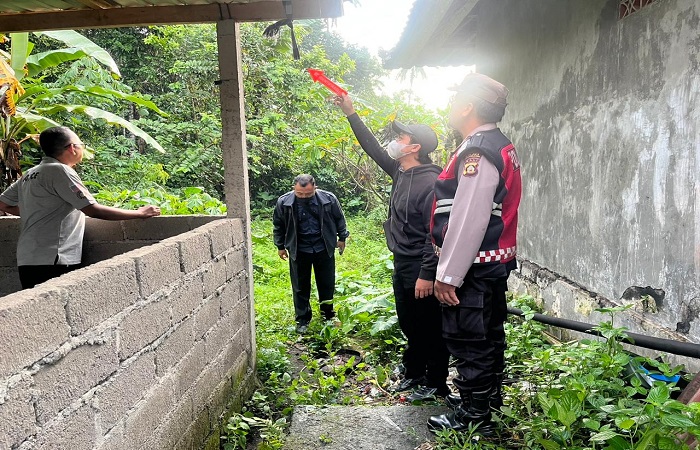 Aparat kepolisian saat melakukan olah TKP di garasi rumah tempat IWS gantung diri, Minggu (28/12) kemarin.