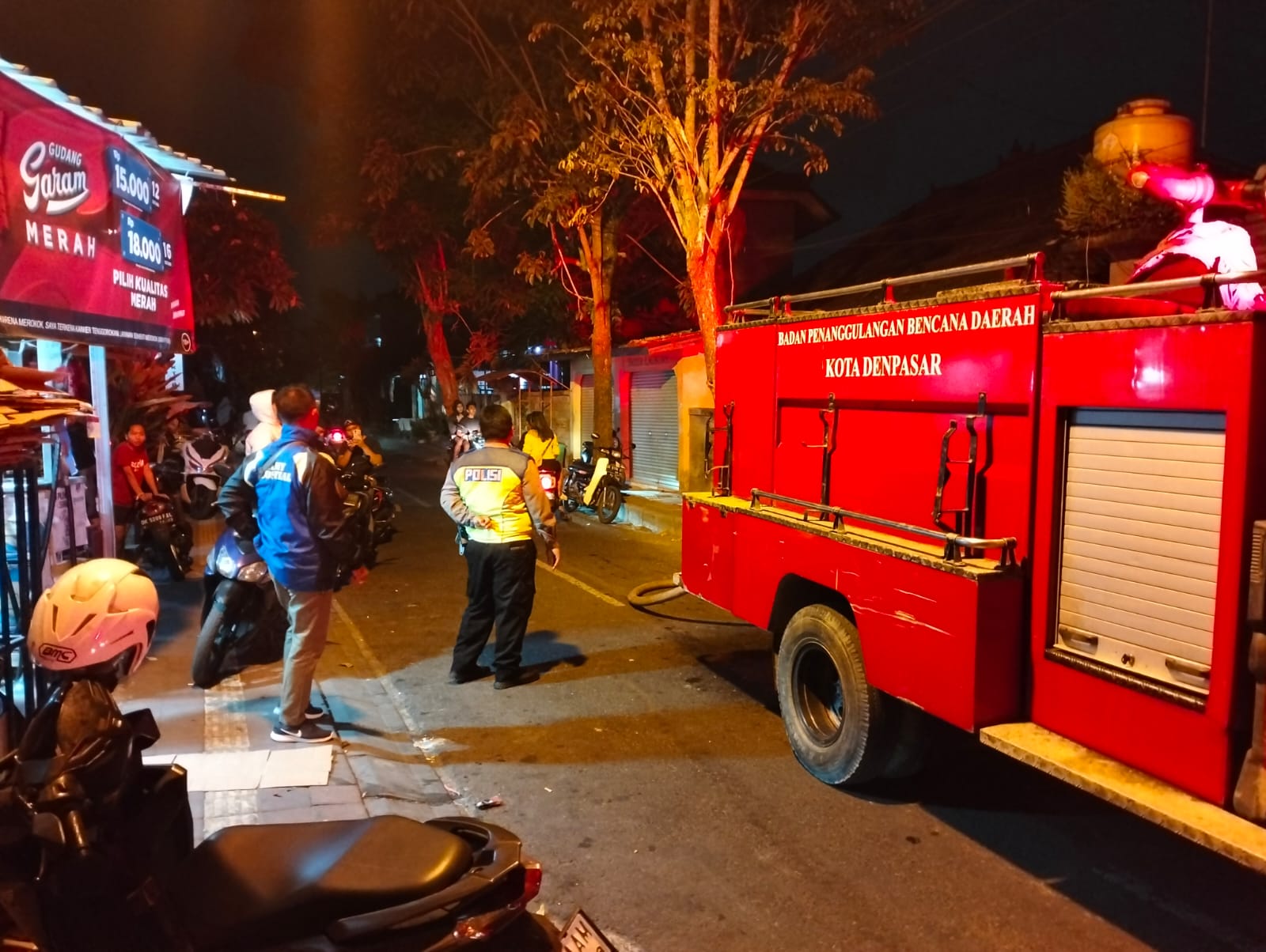 KEBAKARAN: Dua unit pemadam kebakaran melakukan upaya menyemprot nyala api di balai dangin Desa Kesiman, Kertalangu, Dentim, Sabtu 28 Oktober 2023.