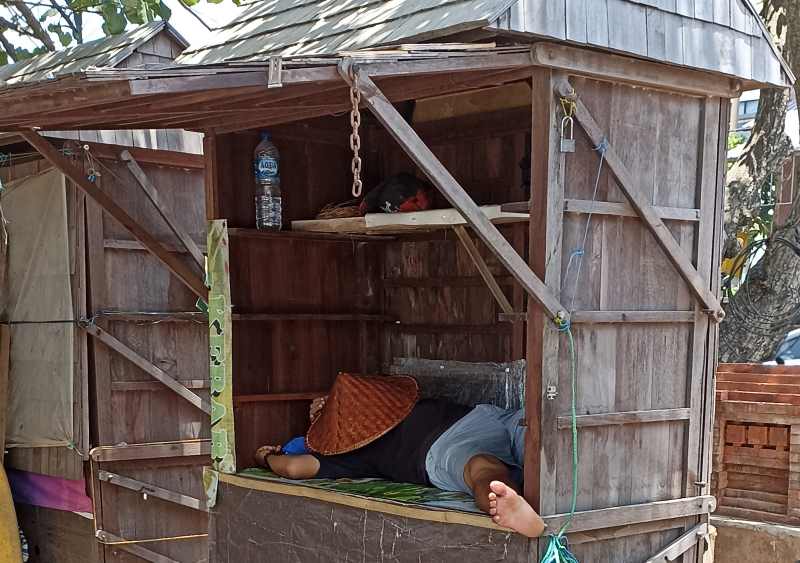 TERLELAP : Lapak berbahan kayu di Pantai Kuta ini dipakai tidur dengan nyaman. (adrian suwanto/radar bali)