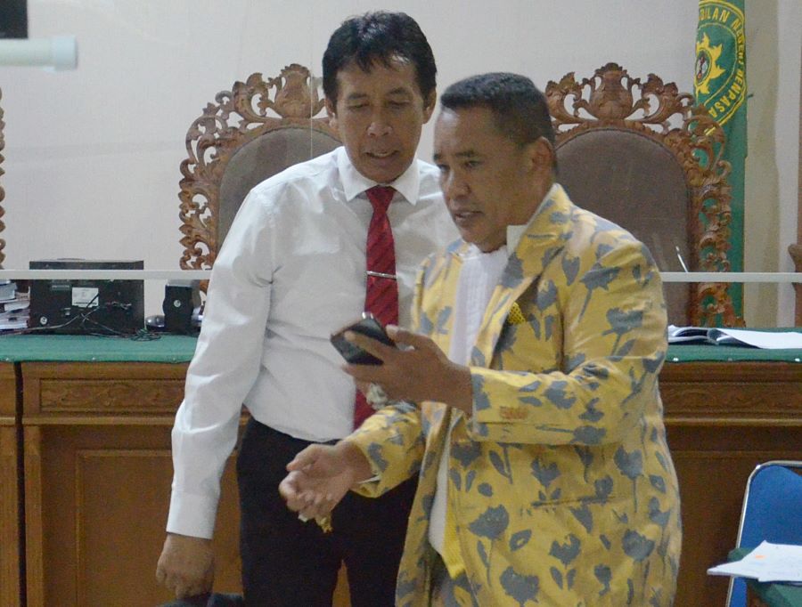TUNJUKKAN BUKTI: Mantan Rektor Unud terdakwa korupsi Dana SPI Prof. Antara (kiri) berbincang sama penasihat hukumnya, Hotman Paris Hutapea, 16 Januari 2024.