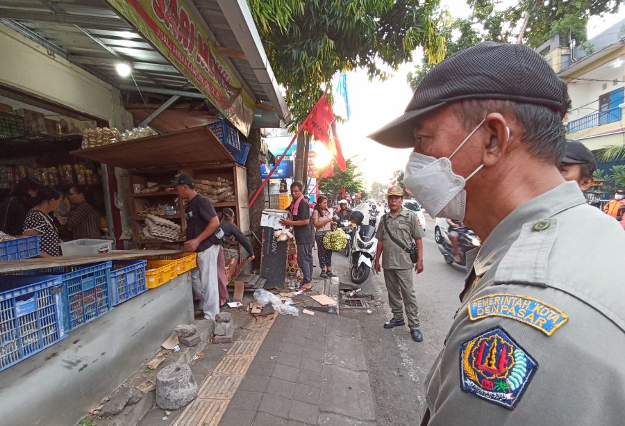GANGGU LALULINTAS: Tim gabungan penertiban Pemkot Denpasar sedang menertibkan pedagang tumpah yang jualan di Trotoar Pasar Sanglah