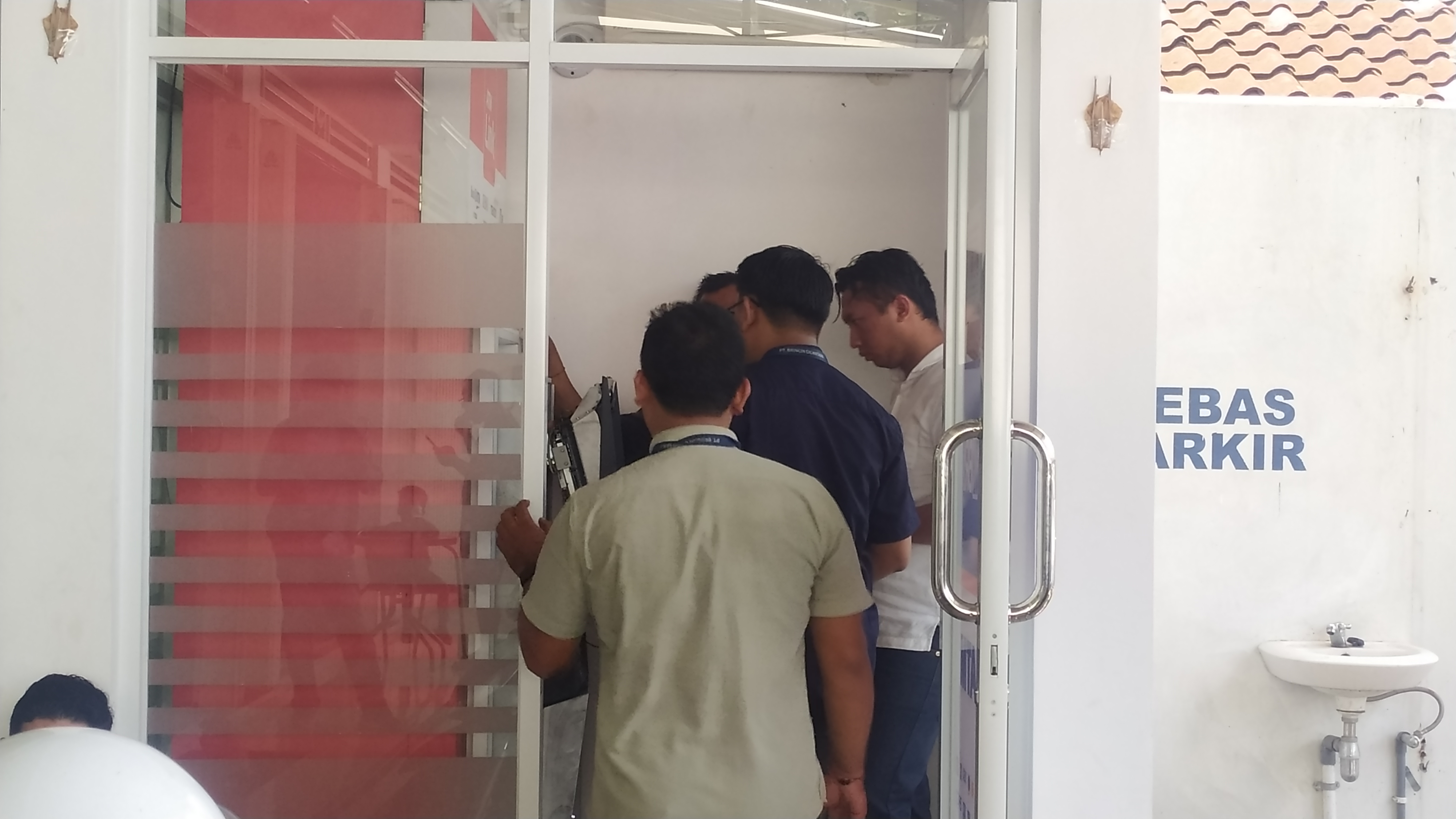 CEK ISI: Sejumlah personil Polres Jembrana dan petugas bank mengecek mesin ATM yang dirusak pelaku pencurian