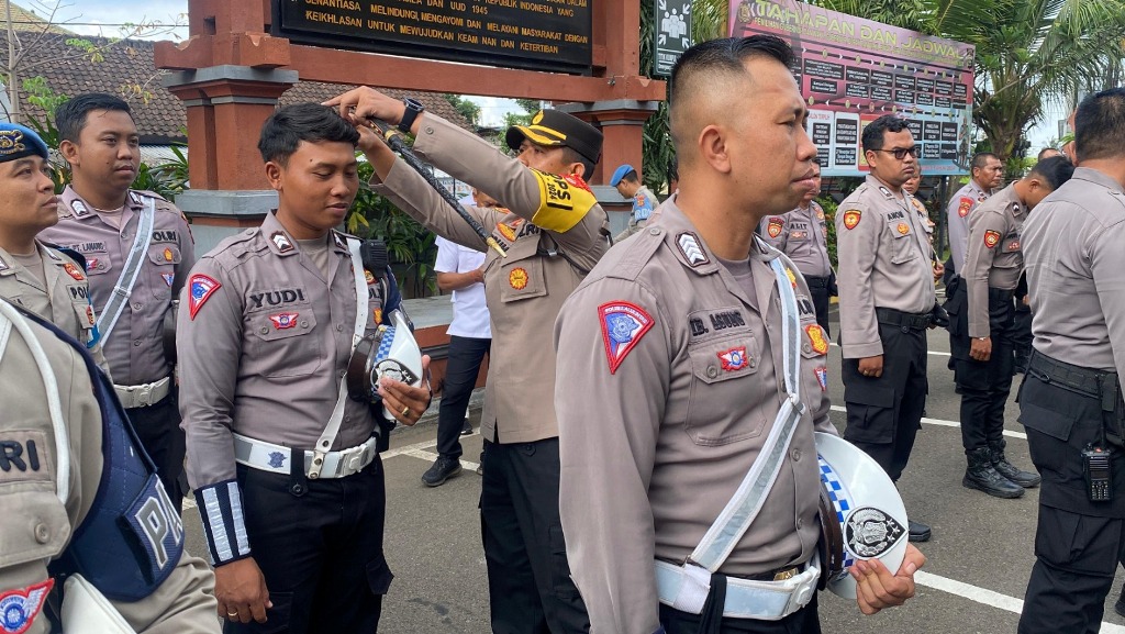 POTONG RAMBUT: Kapolres Badung AKBP Teguh Priyo Wasono saat memotong rambut anggotanya yang tak sesuai Senin (30/9).
