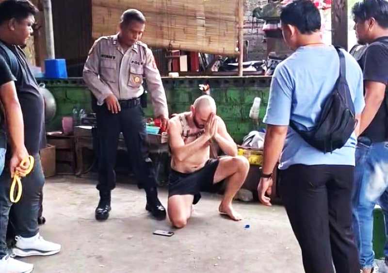 AMPUN-AMPUN SAAT DIDATANGI PETUGAS: Pisarenka Pavel mengacungkan jari tengah ketika difoto, usai diamankan polisi. (Foto: Polres Buleleng untuk Radar Bali)