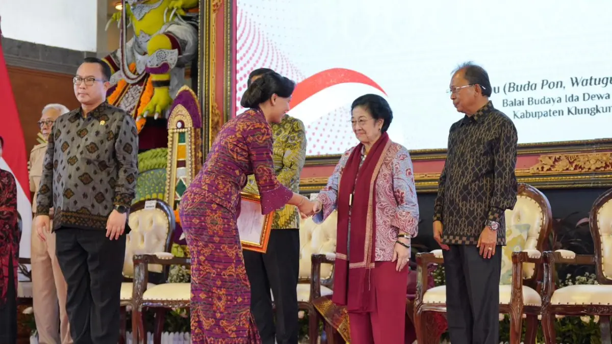 PENGHARGAAN: Dayu Surya Adnyani Mahayastra (kiri) bersalaman dengan Megawati Soekarno Putri dan menerima penghargaan, Rabu (1/4).&nbsp;
