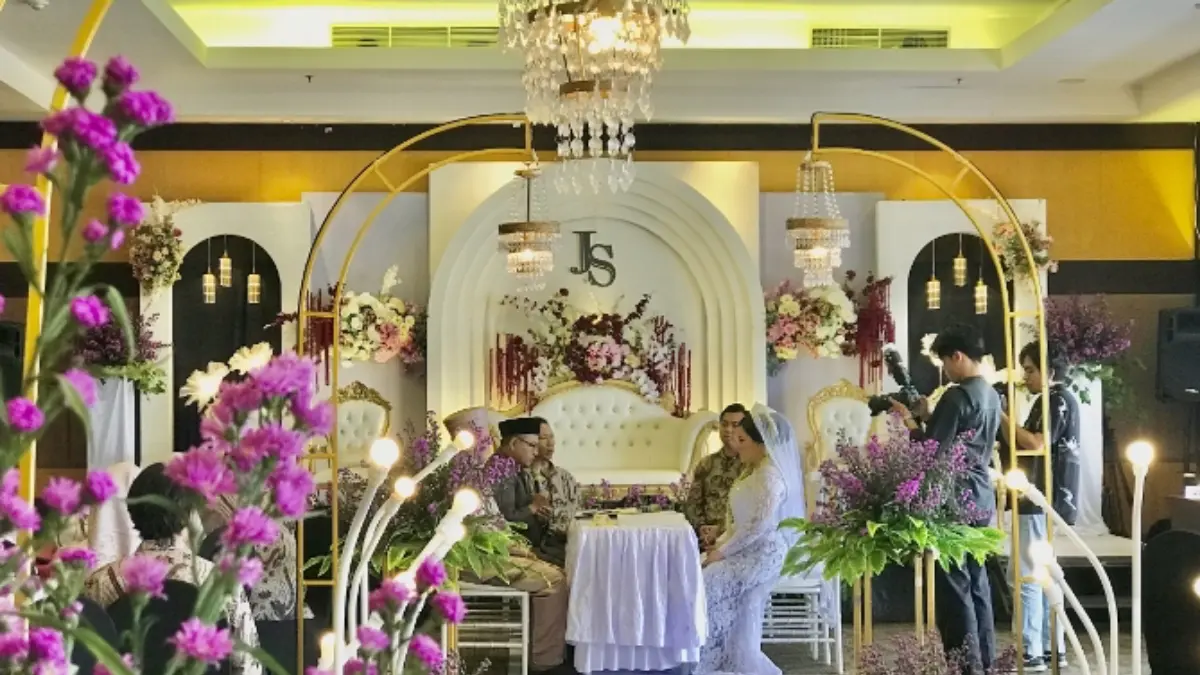 Pasangan pengantin melangsungkan prosesi pernikahan di Quest Hotel Kuta.