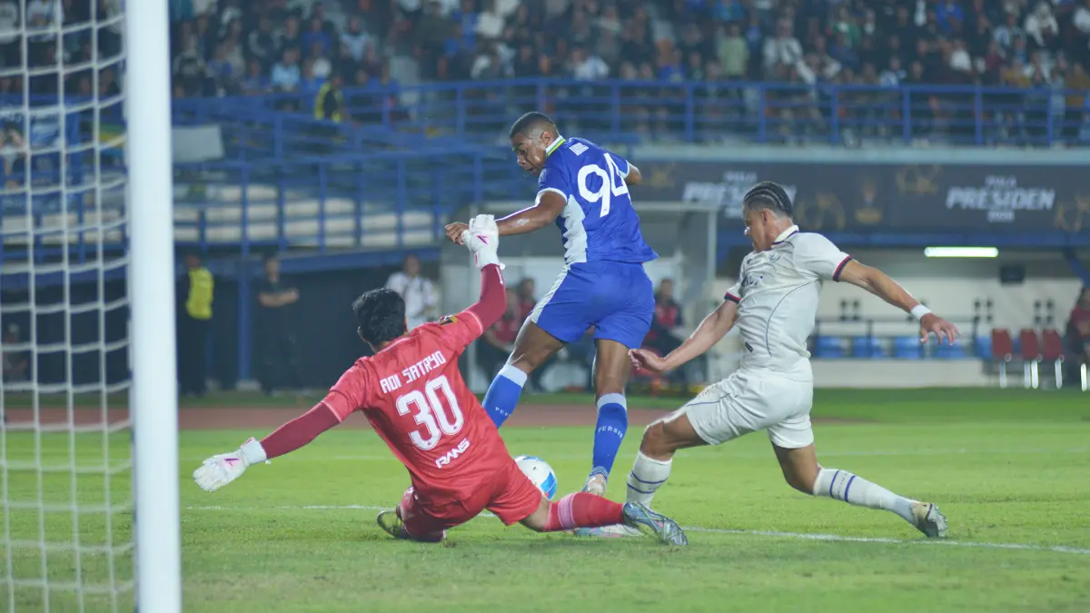 Striker Persib Uilliam Barros (tengah) menceploskan bola ke gawang Arema FC yang dikawal Adi Satriyo dalam pertandingan pembuka Piala Presiden 2026 di Stadion Si Jalak Harupat, Bandung. (Foto: Sutanto Nurhadi Permana/Persib)