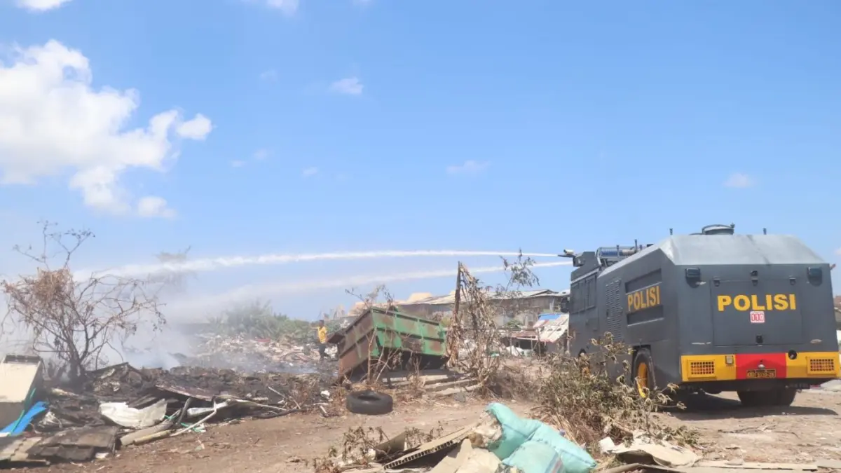 KEPULAN ASAP: Water canon Sat Samapta Polresta Denpasar membantu memadamkan titik api di kawasan gudang rongsokan Jalan Nakula, Gang Jatayu, Legian Kuta, Badung. (ADRIAN SUWANTO/radarbali.id)