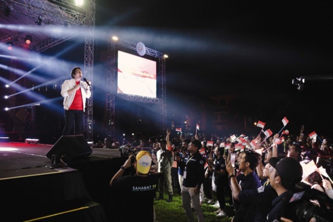 PATRIOTISME: Bupati Badung I Nyoman Giri Prasta saat menyanyikan lagu Indonesia Pusaka serangkaian HUT Mangupura Ke- 13 di Lapangan Puspem Mangupraja Mandala, Jumat (11/11) malam. (HUMAS PEMKAB BADUNG FOR RADAR BALI) 