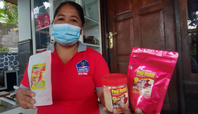 MELEWATI LIKU-LIKU PROSES PERJALANAN : Nyoman Mariani dengan produk minuman herbal yang diproduksi KWT Tulus Bakti dan kini sudah menjadi andalan desa. (foto:eka prasetya/radar bali)_