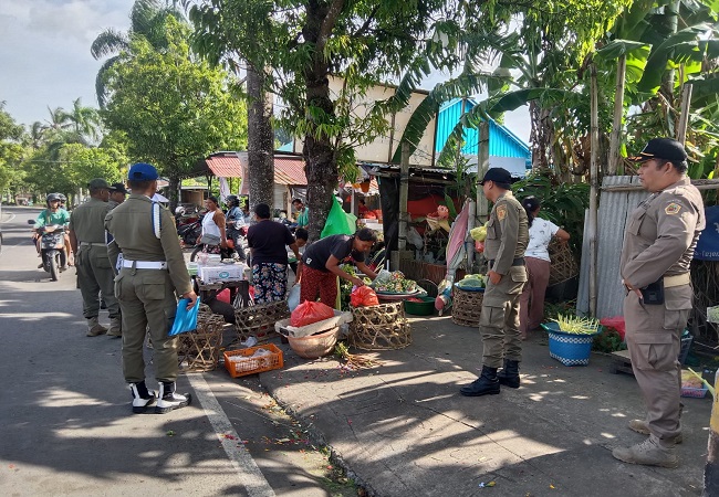 Petugas Satpol PP saat menertibkan sejumlah pedagang di trotoar. (ist)