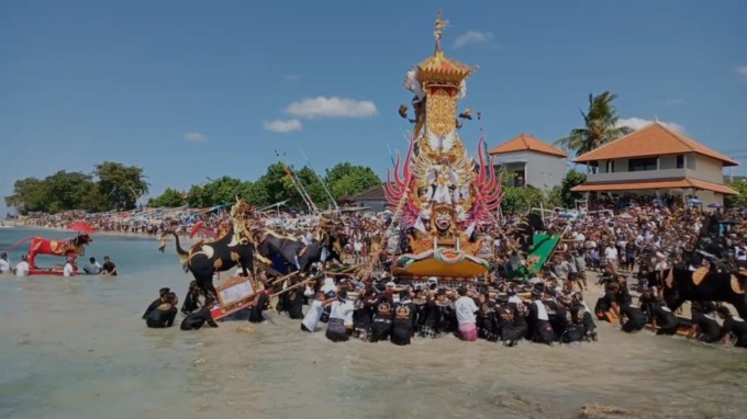 UNIK: Ratusan warga mengarak bade dan petulangan ke pesisir pantai Pantai Batumulapan dan Kutapang, Rabu (17/5). Foto: Radar Bali Photo