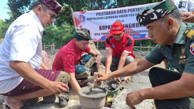 SUDAH BATU PERTAMA : Bupati Klungkung, I Nyoman Suwirta melakukan peletakan batu pertama revitalisasi Lapangan Umum Pau, Desa Tihingan, Kecamatan Banjarangkan. (Foto: Humas Pemkab Klungkung).